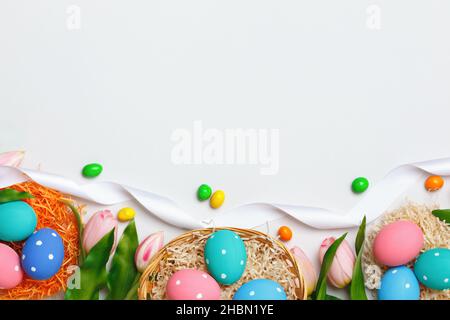 Easter composition on a gray background. Egg basket tulips. Banner frame border flat lay top view copy space Stock Photo