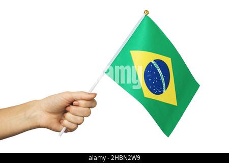 Hand holds Brazilian flag isolated on white background, template for designers Stock Photo