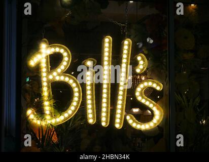 Bills restaurant yellow neon sign in Westfield, White City, London Stock Photo