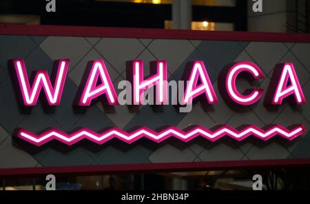 Red and White Neon sign of Wahaca Mexican street food restaurant in Westfield, White City, London Stock Photo
