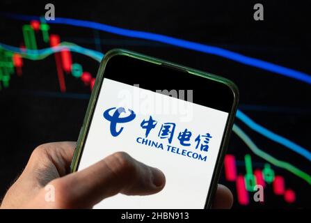 China. 4th Dec, 2021. In this photo illustration the Chinese state-owned telecommunications company China Telecom logo seen displayed on a smartphone with an economic stock exchange index graph in the background. (Credit Image: © Budrul Chukrut/SOPA Images via ZUMA Press Wire) Stock Photo