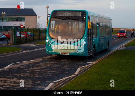 An Arriva bus working in Redcar with a Covid safety mask painted on the front Stock Photo