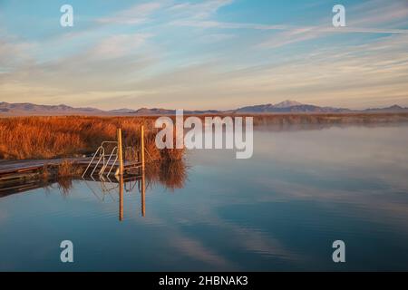 BLUE LAKE, UNITED STATES - Nov 04, 2021: A dock and ladder offers swimmers and divers access to Blue Lake's warm springs thermal waters. Stock Photo