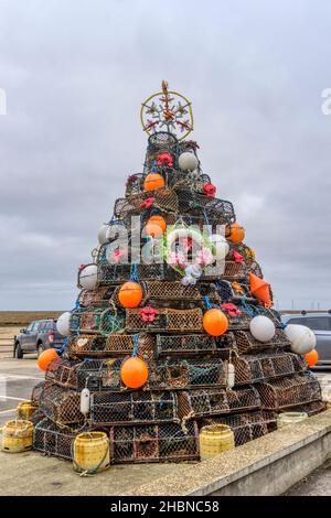 Christmas tree on the harbour at Wells-next-the-Sea in north Norfolk made out of crab and whelk pots from the local fishing fleet. Stock Photo