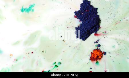 Liquid White Layout Ink Top view of dry colorful inks falling in white liquid substance ...