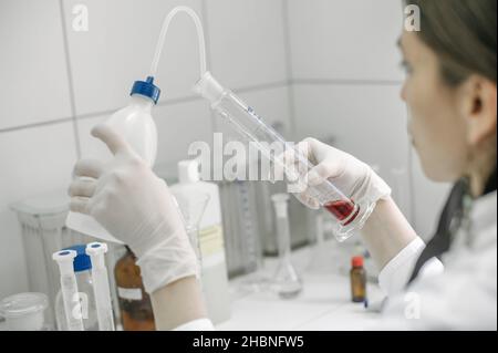 Female laboratory researcher performs tests in the medical or scientific lab Stock Photo