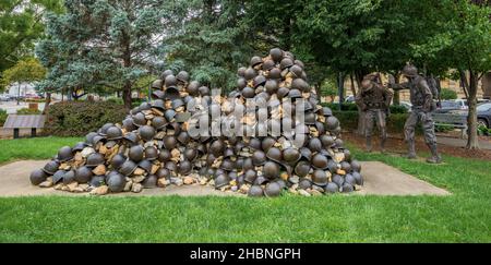 Zanesville, OH - Sept. 8, 2021: This pile of helmets and bronze figures are part of the WWII Korean War Memorial honoring the fallen men from Muskingu Stock Photo