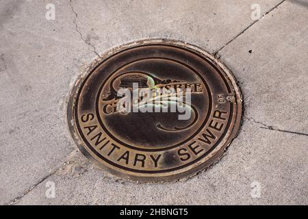 Bisbee, AZ - Oct. 10, 2021: This sanitary sewer manhole cover features the official seal of the City of Bisbee with a design referencing the town's mi Stock Photo