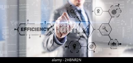 Efficiency. Businessman presses the inscription on the virtual screen. Stock Photo