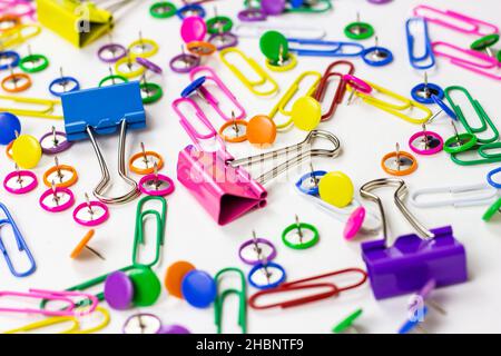Bright pink, yellow, blue and green stationery accessories for office and education on white background. Stock Photo