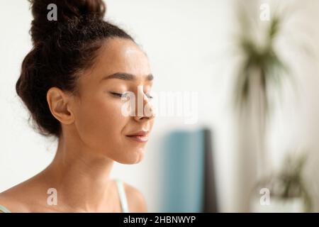 Closeup Portrait Of Calm Young Beautiful Woman Sitting With Closed Eyes Stock Photo