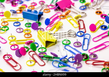Bright pink, yellow, blue and green stationery accessories for office and education on white background. Stock Photo