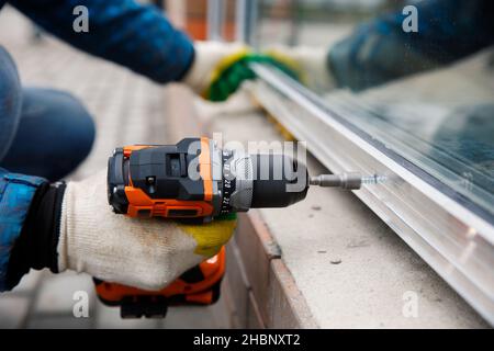 The wizard is engaged in installing windows. Repair work. Stock Photo