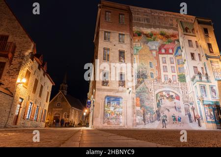 Quebec, Canada - October 18 2021 : Fresco Wall Art in the Quebec City Old Town in autumn night. Mural of Quebecers. Stock Photo