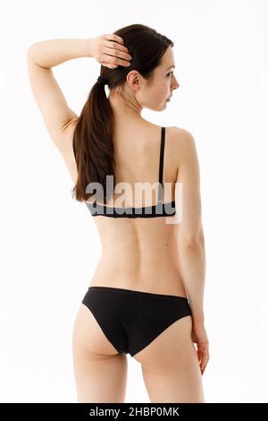 Model tests. Snap Models back view, Beautiful brunette woman in underwear,  isolated on white Stock Photo - Alamy
