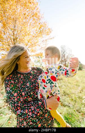 Portrait of a mother and toddler daughter laughing together Stock Photo