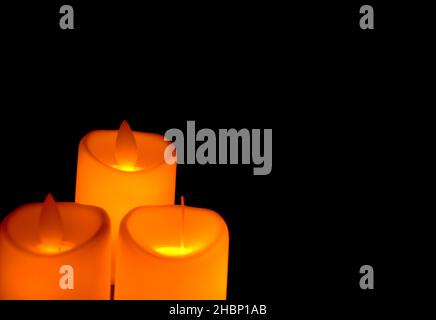 Orange candle with light shines in the shadows. Advent concept Stock Photo