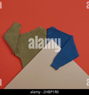 Yellow and Blue Sweater on Red Background Stock Photo