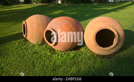 Large earthenware jars for garden decoration with rustic horizontal green grass Stock Photo