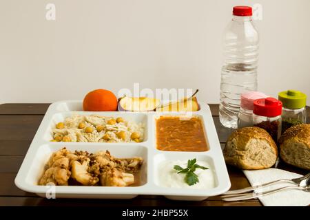 Traditional Turkish rice made with chickpeas and chicken and cooked cauliflower with mince in tray table d'hote on wooden table Stock Photo