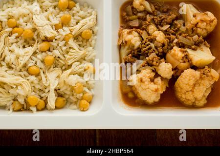 Traditional Turkish rice made with chickpeas and chicken and cooked cauliflower with mince in tray table d'hote on wooden table Stock Photo