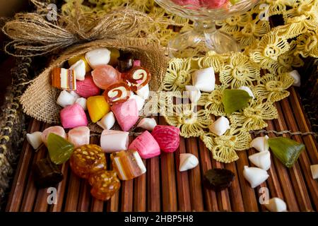 Colorful,Traditional Turkish hard candy is Akide in wooden tray with handmade lace cloth.The Sugar Feast concept. Stock Photo