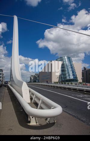 Samuel Beckett Bridge -  rotatable road  and cable-stayed bridge in Dublin, view at The Convention Centre and IFSC House, Docklands, Dublin, Ireland, Stock Photo