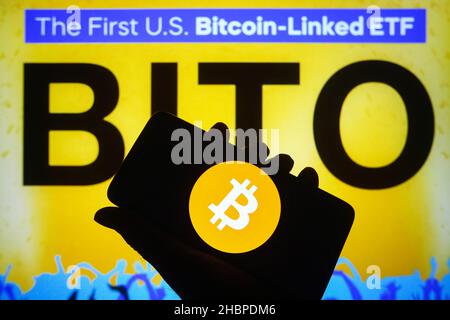 Ukraine. 20th Dec, 2021. In this photo illustration, a Bitcoin cryptocurrency sign is seen on a smartphone screen and ProShares Bitcoin Strategy ETF (BITO) logo of the first U.S. bitcoin-linked ETF in the background. Credit: SOPA Images Limited/Alamy Live News Stock Photo