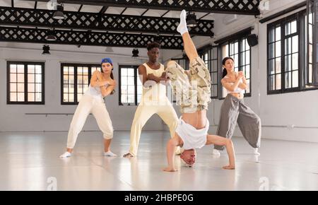 Young man doing headstand while dancing breakdance Stock Photo