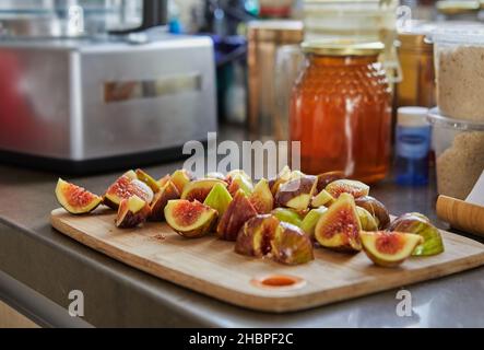 Figs lie on wooden board in the kitchen and jar of honey to bake recipe from the Internet Stock Photo
