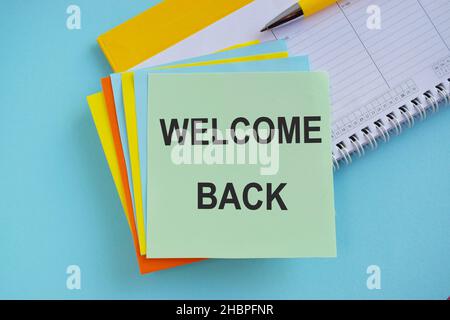 Welcome back sign - text inscription on colorful sticker, blue background, business concept Stock Photo
