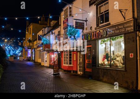 Shops with christmas decorations along Middle Row at night. Chipping norton, Cotswolds, Oxfordshire, England Stock Photo