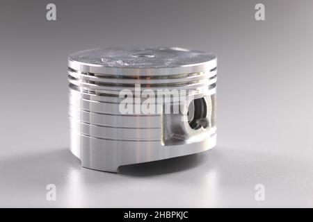 Metal new part for internal combustion engine placed in grey background Stock Photo