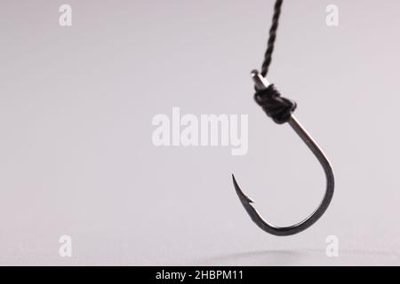 Hook attached to steel cable, single fish hook Stock Photo