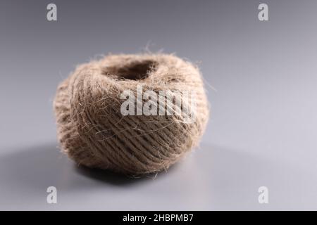 Brown rope roll, skein of jute twine on grey background Stock Photo