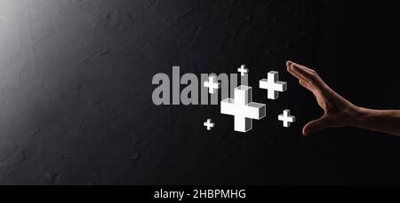 Hand hold 3D plus icon, man hold in hand offer positive thing such as profit, benefits, development, CSR represented by plus sign.The hand shows the p Stock Photo