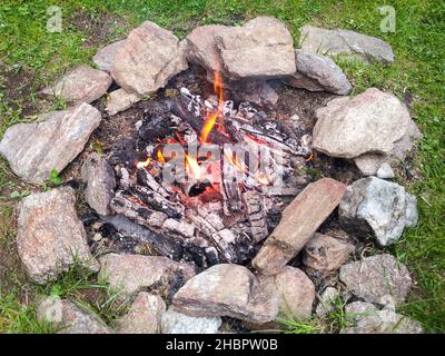 Campfire, Burning, burning, fire, fireplace, stones, holiday, meadow, from, above, camping, outdoor, outdoors, flames, hot barbecue Stock Photo