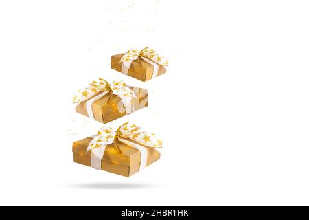 Golden gift boxes falling down isolated on white background. Stock Photo