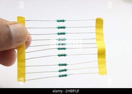 A small pack of resistors held in hand isolated on white background Stock Photo