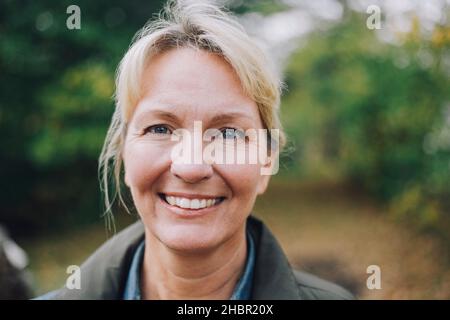 Smiling mature woman in back yard Stock Photo