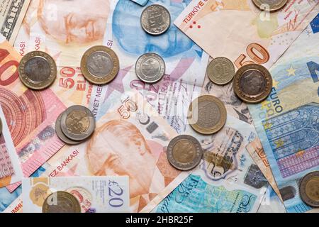 Background from paper money of the different countries,us dollars,euros,sterlings,turkish liras financial crisis.Paper bills of various denominations, scattered, top view. Stock Photo