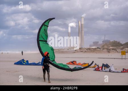 Kite-surfers walk at the shores of the Mediterranean sea close to the city of Ashkelon, southern Israel Stock Photo