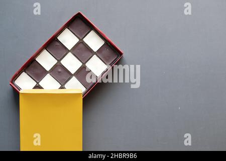 dark and white chocolate in a box on gray background  Stock Photo