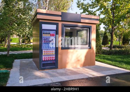 A new, unopened refreshment mart, kiosk with a sticker, picture of a refrigerator in the Victims of Repression park. In Tashkent, Uzbekistan. Stock Photo