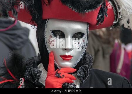 VENEZIA, ITALY - Mar 05, 2019: A Masked woman as a Musketeer. The Carnival of Venice. Stock Photo