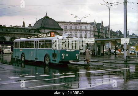 A bus at the bus station at front of the city railway station, Lucerne (Lucern), Switzerland in 1967. The bus parked has a destination board indicating ‘Lucern Bahnhof’. The first station was opened on edge of Lake Lucerne in 1856 at the end of the Schweizerische–Centralbahn main line from Olten and Basel. A new station was opened in 1896 with a large new building with a distinctive cupola (here partially seen behind the bus). A new station was built, opening in 1991 – a vintage 1960s photograph. Stock Photo