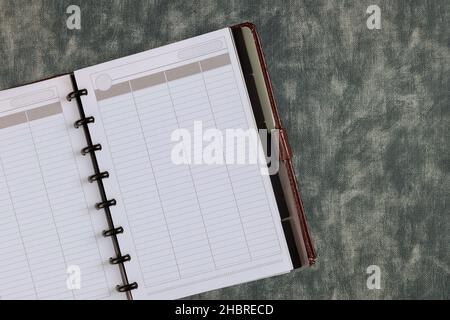 Top view with notebook blank page is in the middle of office desk Stock Photo