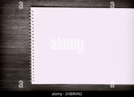 Blank notepad for sketching with white pages  isolated on wooden desk Stock Photo