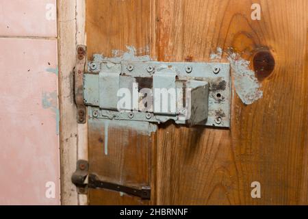 A huge homemade deadbolt lock on the door of the production room. Stock Photo