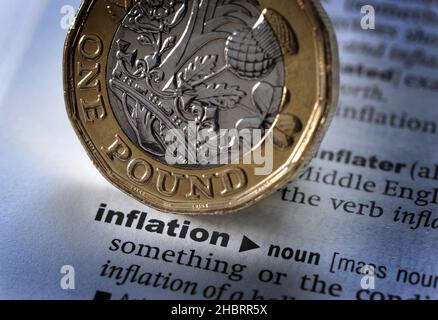 DICTIONARY DEFINITION OF WORD INFLATION WITH ONE POUND COIN RE THE ECONOMY SAVINGS HOUSEHOLD BUDGETS ETC UK Stock Photo